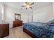 Bedroom featuring a double closet, wood-look floors, ceiling fan, and a big window at 4793 Antrim Dr, Sarasota, FL 34240