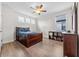 This bedroom includes a ceiling fan, three windows, and luxury vinyl plank flooring at 4793 Antrim Dr, Sarasota, FL 34240