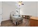 Cozy bedroom featuring a metal bed frame, luxury vinyl plank floors, and a ceiling fan at 4793 Antrim Dr, Sarasota, FL 34240