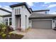 Close-up of a modern home with a two-car garage and well-kept landscaping at 4793 Antrim Dr, Sarasota, FL 34240