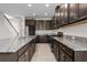 Large kitchen with stainless steel appliances, granite counters, and dark wood cabinetry at 4793 Antrim Dr, Sarasota, FL 34240