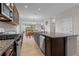 Open kitchen featuring granite countertops, dark cabinets, and a tile backsplash at 4793 Antrim Dr, Sarasota, FL 34240