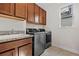 Modern laundry room with granite countertops and sleek, modern washer and dryer at 4793 Antrim Dr, Sarasota, FL 34240