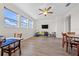 Spacious living room features a ceiling fan, three windows, and luxury vinyl plank flooring at 4793 Antrim Dr, Sarasota, FL 34240