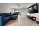 Spacious living room with large sectional sofa and access to the backyard at 4793 Antrim Dr, Sarasota, FL 34240