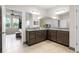 A bright main bathroom featuring dual vanities, large mirrors, and a tiled floor at 4793 Antrim Dr, Sarasota, FL 34240