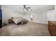This well-lit main bedroom features a ceiling fan, tiled floor, and neutral walls at 4793 Antrim Dr, Sarasota, FL 34240