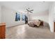 Spacious main bedroom with a ceiling fan, natural light from the windows, and neutral tile floors at 4793 Antrim Dr, Sarasota, FL 34240