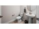 Classic powder room with pedestal sink, brass hardware, and towel bar at 4793 Antrim Dr, Sarasota, FL 34240