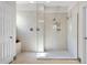 This beautifully tiled shower features dual shower heads, inset shelving and a glass door at 4793 Antrim Dr, Sarasota, FL 34240