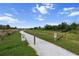 A peaceful community walking path with lush greenery offers residents a serene escape for exercise and relaxation at 4793 Antrim Dr, Sarasota, FL 34240