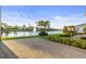 Paver patio with manicured landscaping and a beautiful water view with fountain feature at 5074 Surfside Cir, Bradenton, FL 34211