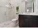 Bathroom featuring walk-in shower with glass door, stylish vanity, and neutral wall color at 5074 Surfside Cir, Bradenton, FL 34211
