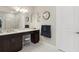 Bathroom features double vanity, large mirror, and walk-in shower with neutral color palette at 5074 Surfside Cir, Bradenton, FL 34211