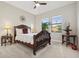 Bedroom features a decorative wooden headboard, a ceiling fan, and an abundance of natural light at 5074 Surfside Cir, Bradenton, FL 34211