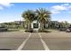 Elegant clubhouse featuring lush landscaping, palm trees, and convenient parking for residents and guests at 5074 Surfside Cir, Bradenton, FL 34211