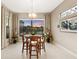 Dining room with views of the lake, a unique light fixture, and light-colored walls at 5074 Surfside Cir, Bradenton, FL 34211