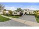 Beautiful single-Gathering home featuring a well-manicured lawn and a paved driveway leading to a two-car garage at 5074 Surfside Cir, Bradenton, FL 34211
