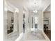 Bright foyer with tile flooring, chandelier, mirror and view to a decorative front door at 5074 Surfside Cir, Bradenton, FL 34211