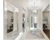 Light-filled foyer featuring a chandelier, a mirror, tile flooring, and a view to the front door at 5074 Surfside Cir, Bradenton, FL 34211