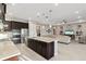 Kitchen island featuring granite counters, stainless appliances, and an open view to the living room at 5074 Surfside Cir, Bradenton, FL 34211