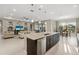 Open-concept kitchen with a large island, stainless steel appliances, and seamless flow to the living and dining areas at 5074 Surfside Cir, Bradenton, FL 34211