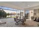 Screened lanai with comfortable seating, dining table, and a beautiful water view with fountain feature at 5074 Surfside Cir, Bradenton, FL 34211