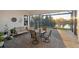 Screened lanai with comfortable seating, dining table, and a view of the tropical landscape at 5074 Surfside Cir, Bradenton, FL 34211