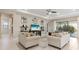 Bright living room with neutral decor, comfortable seating, and sliding glass doors to the outdoor living space at 5074 Surfside Cir, Bradenton, FL 34211