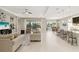 Bright, open-concept living room, kitchen, and dining area featuring a view to a lake at 5074 Surfside Cir, Bradenton, FL 34211