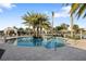 Resort-style pool featuring a luxurious pool with surrounding lounge area, cabanas and palm trees at 5074 Surfside Cir, Bradenton, FL 34211