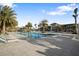 Resort-style pool with lounge chairs and swaying palm trees, perfect for relaxation and recreation at 5074 Surfside Cir, Bradenton, FL 34211