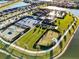 Aerial view of well-maintained tennis courts and sports facilities surrounded by lush landscaping at 5074 Surfside Cir, Bradenton, FL 34211