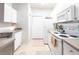 Well-lit kitchen with white cabinets, modern appliances, and ample counter space at 5122 Northridge Rd # 110, Sarasota, FL 34238