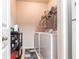 Convenient laundry room with washer, dryer, and storage shelves for supplies at 5122 Northridge Rd # 110, Sarasota, FL 34238