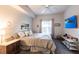 Comfortable main bedroom features a ceiling fan, a decorative print, and a wall-mounted television at 5122 Northridge Rd # 110, Sarasota, FL 34238