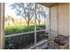 Relaxing screened porch with comfortable seating and peaceful views of the green landscape at 5122 Northridge Rd # 110, Sarasota, FL 34238