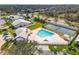 An aerial view showcases the community pool and tennis court, nestled in a scenic neighborhood at 5320 Crestlake Blvd # 26, Sarasota, FL 34233