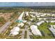 A landscape aerial view of a community featuring a community pool, ponds, and well-maintained landscaping at 5320 Crestlake Blvd # 26, Sarasota, FL 34233