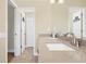 Bright bathroom with double sinks, white cabinets, and large mirror over the quartz countertop at 5320 Crestlake Blvd # 26, Sarasota, FL 34233