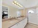 Bright bathroom with double sinks, white shower, and large mirror over the quartz countertop at 5320 Crestlake Blvd # 26, Sarasota, FL 34233