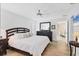 Bright bedroom with hardwood floors, ceiling fan, large bed, and dark wooden furniture at 5320 Crestlake Blvd # 26, Sarasota, FL 34233