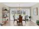 Bright dining room with a glass table, four chairs, and sliding glass doors to the outside at 5320 Crestlake Blvd # 26, Sarasota, FL 34233