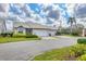 Exterior daytime view of a single-story home with a two-car garage and a well-manicured lawn at 5320 Crestlake Blvd # 26, Sarasota, FL 34233