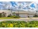Well-maintained single-story home with attached garage, lovely landscaping, and a white tile roof at 5320 Crestlake Blvd # 26, Sarasota, FL 34233