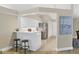 Galley kitchen with white cabinets, stainless steel appliances, and a breakfast bar with bar stool seating at 5320 Crestlake Blvd # 26, Sarasota, FL 34233