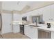 Well-lit kitchen with white cabinetry, stainless steel appliances and open to the dining area at 5320 Crestlake Blvd # 26, Sarasota, FL 34233