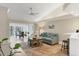 Inviting living space features wood floors, ceiling fan, and sliding glass doors to a screened lanai at 5320 Crestlake Blvd # 26, Sarasota, FL 34233