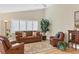 Comfortable living room with white shutters, ceiling fan, and stylish, comfortable furniture and hardwood floors at 5320 Crestlake Blvd # 26, Sarasota, FL 34233