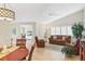 Comfortable living room with vaulted ceiling, white shutters, ceiling fan, and stylish, comfortable furniture at 5320 Crestlake Blvd # 26, Sarasota, FL 34233